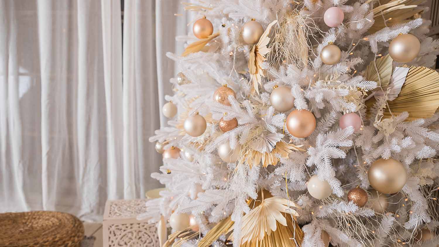 shiny pastel metallic ornaments on white christmas tree