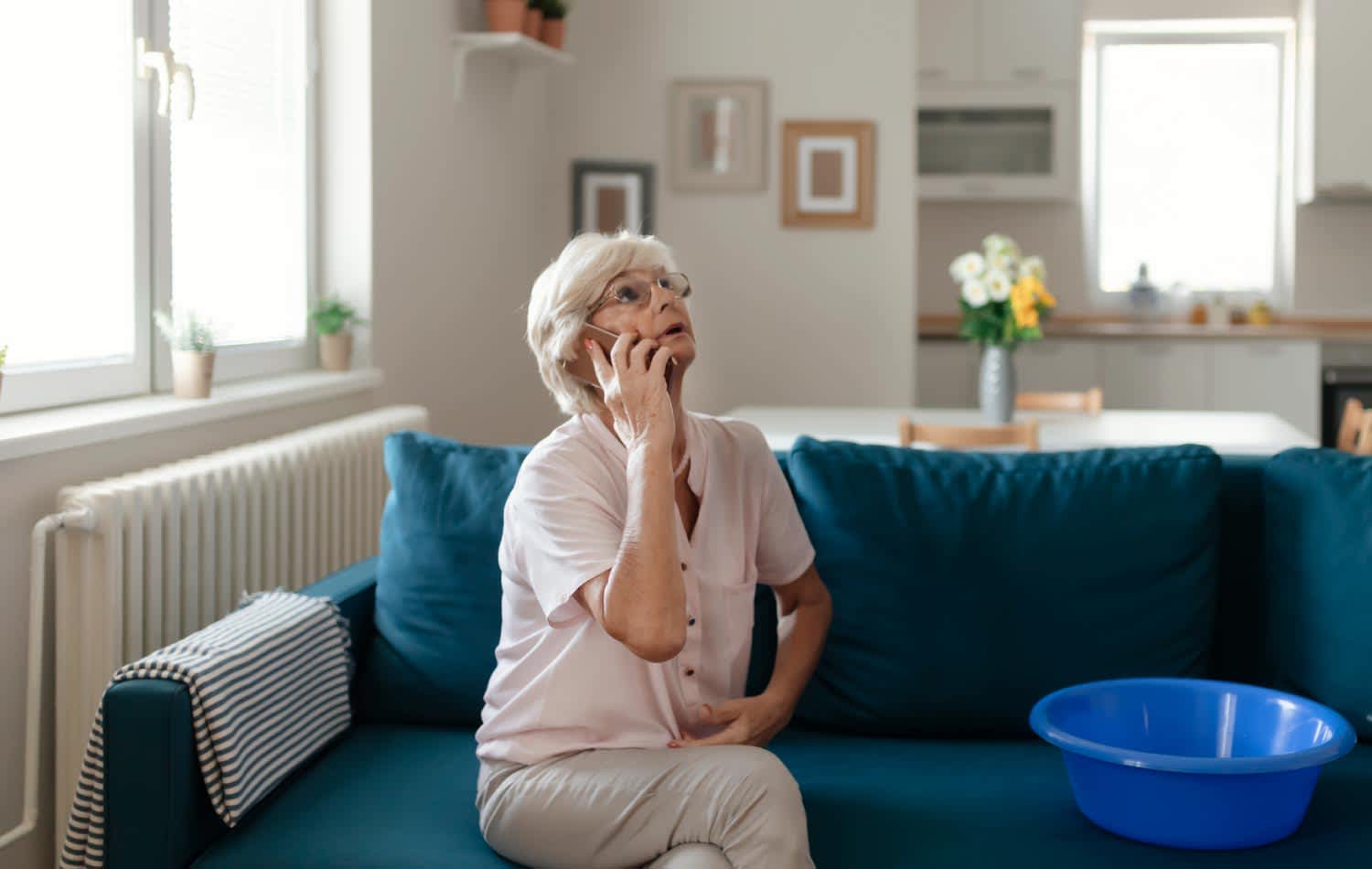 A woman calling a plumber for water leakage