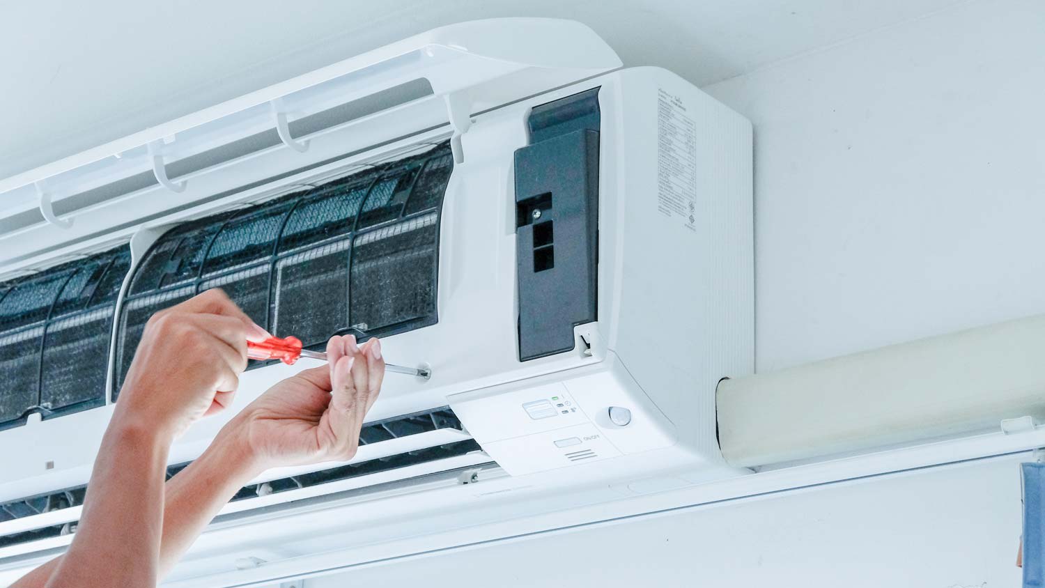 Close-up of a hand repairing the AC