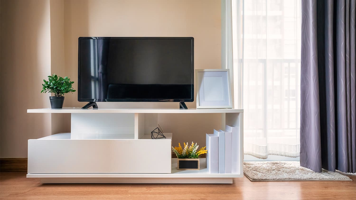 Tv sitting on white tv stand