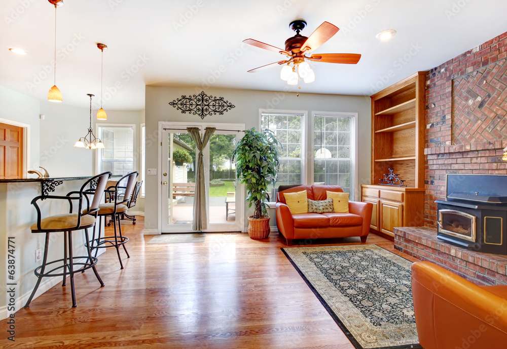 A living room with a ceiling fan with a light