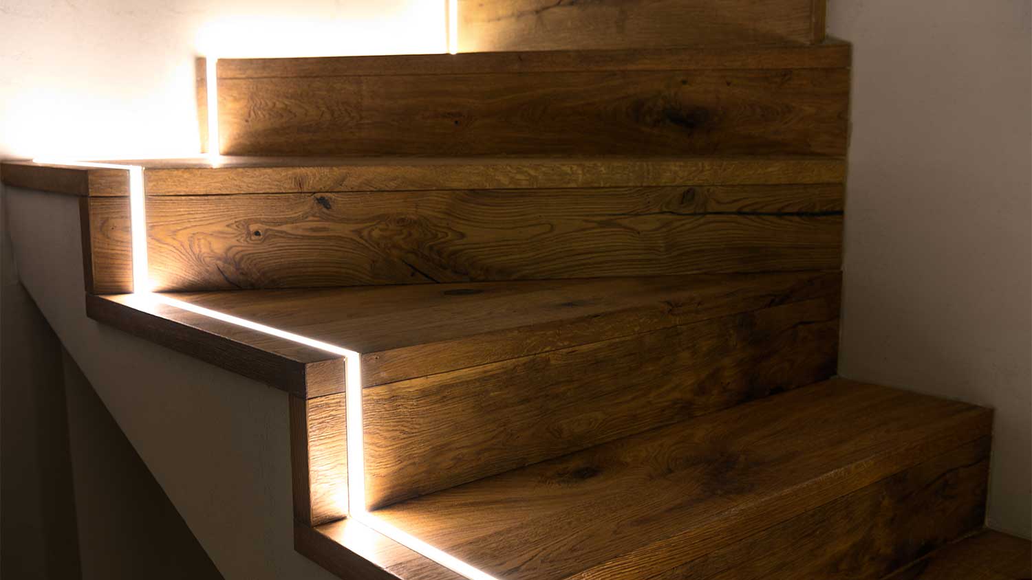 A view of stairs with an LED light strip