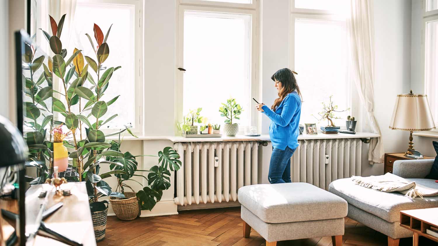 Woman using mobile phone in living room