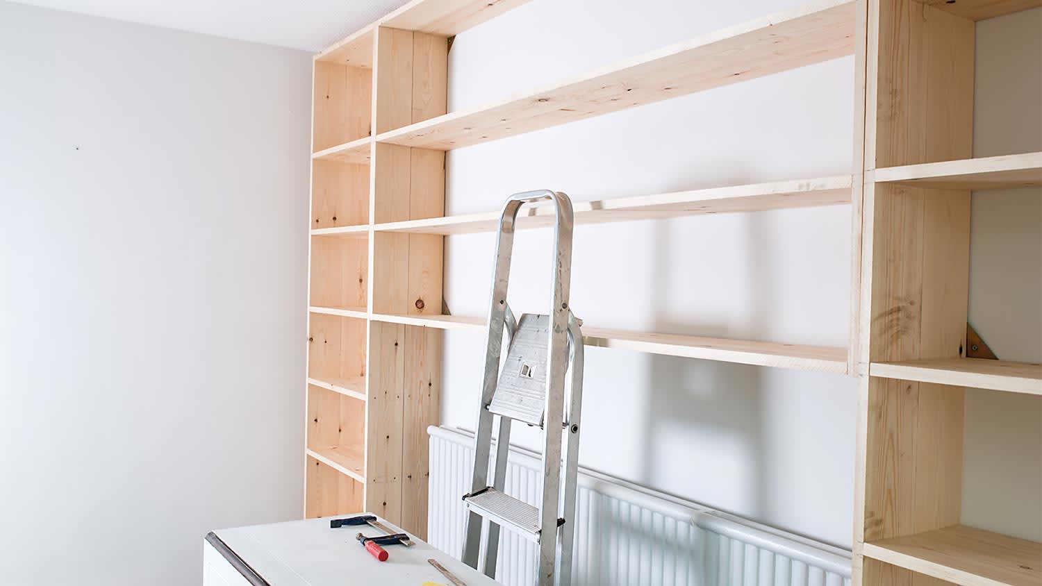 wooden bookshelves being made in living room