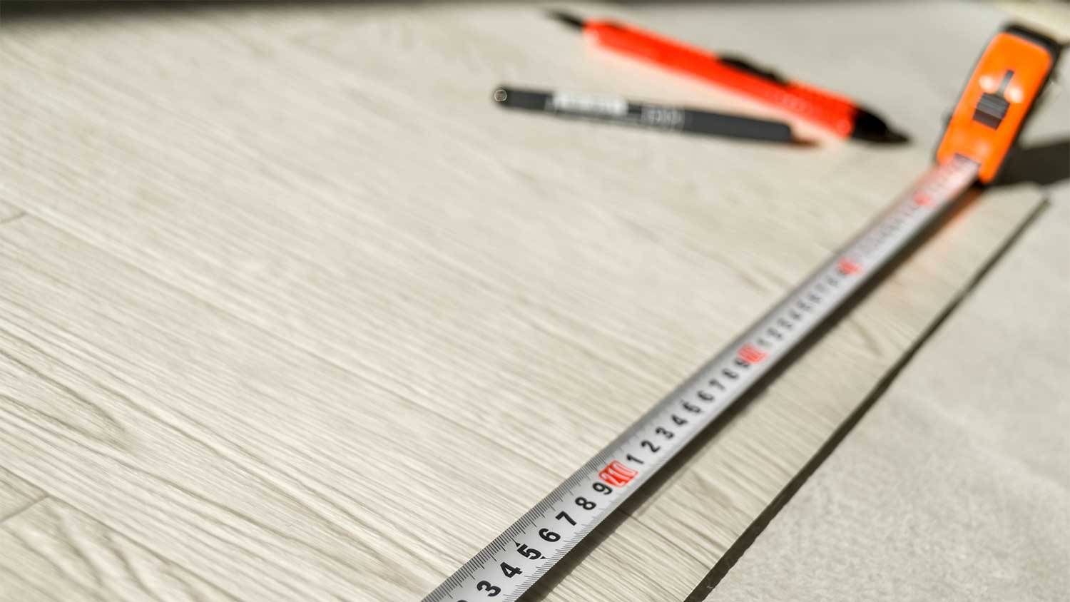 A view of linoleum, measuring tape, and tools
