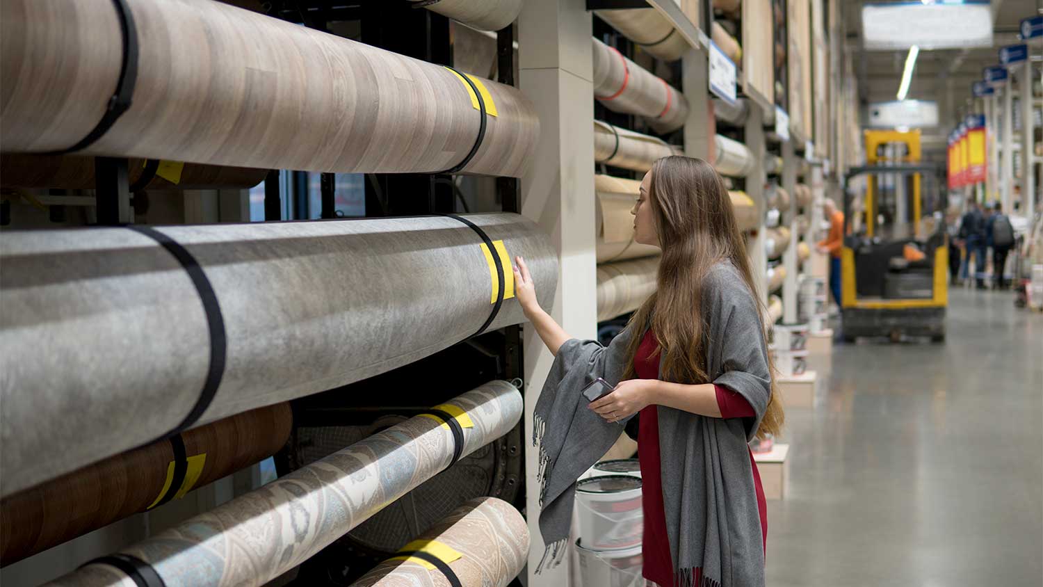 A woman selects linoleum flooring