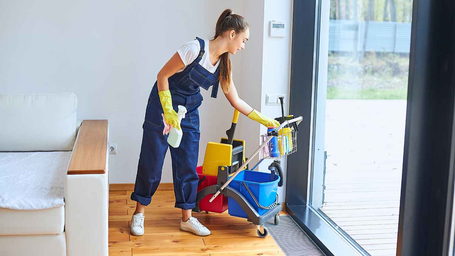 Woman using a cleaning trolley around the house