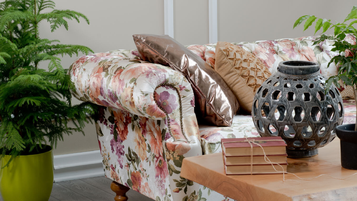 Patterned sofa next to coffee table and potted plant