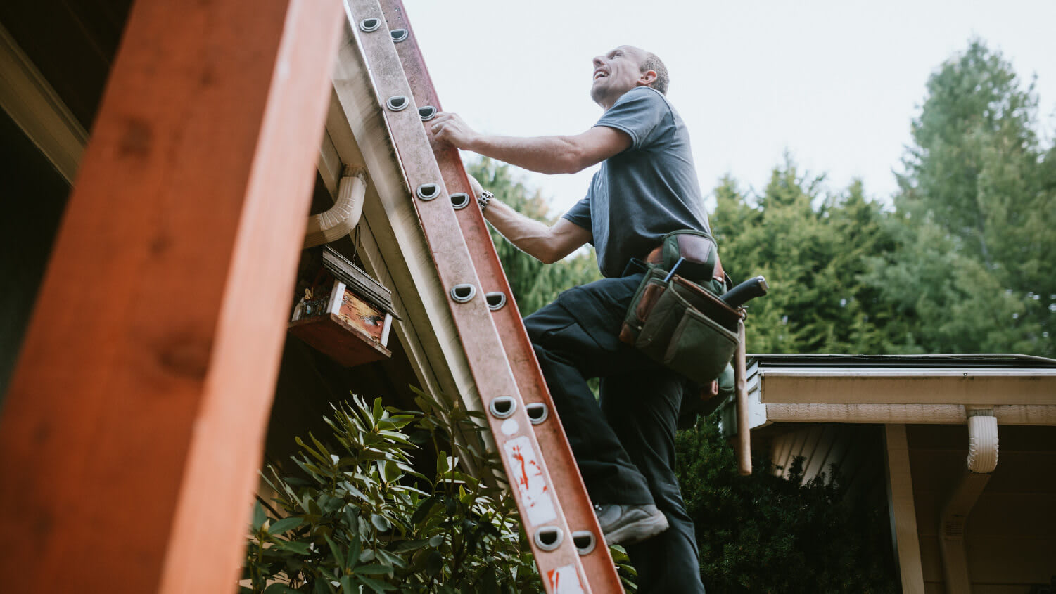 man outside on ladder