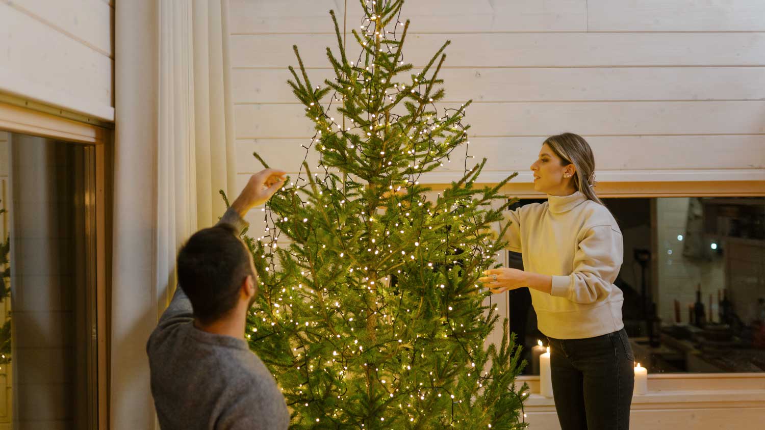 Couple decorating home for Christmas