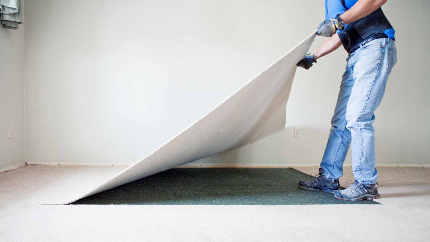 Man removing carpet