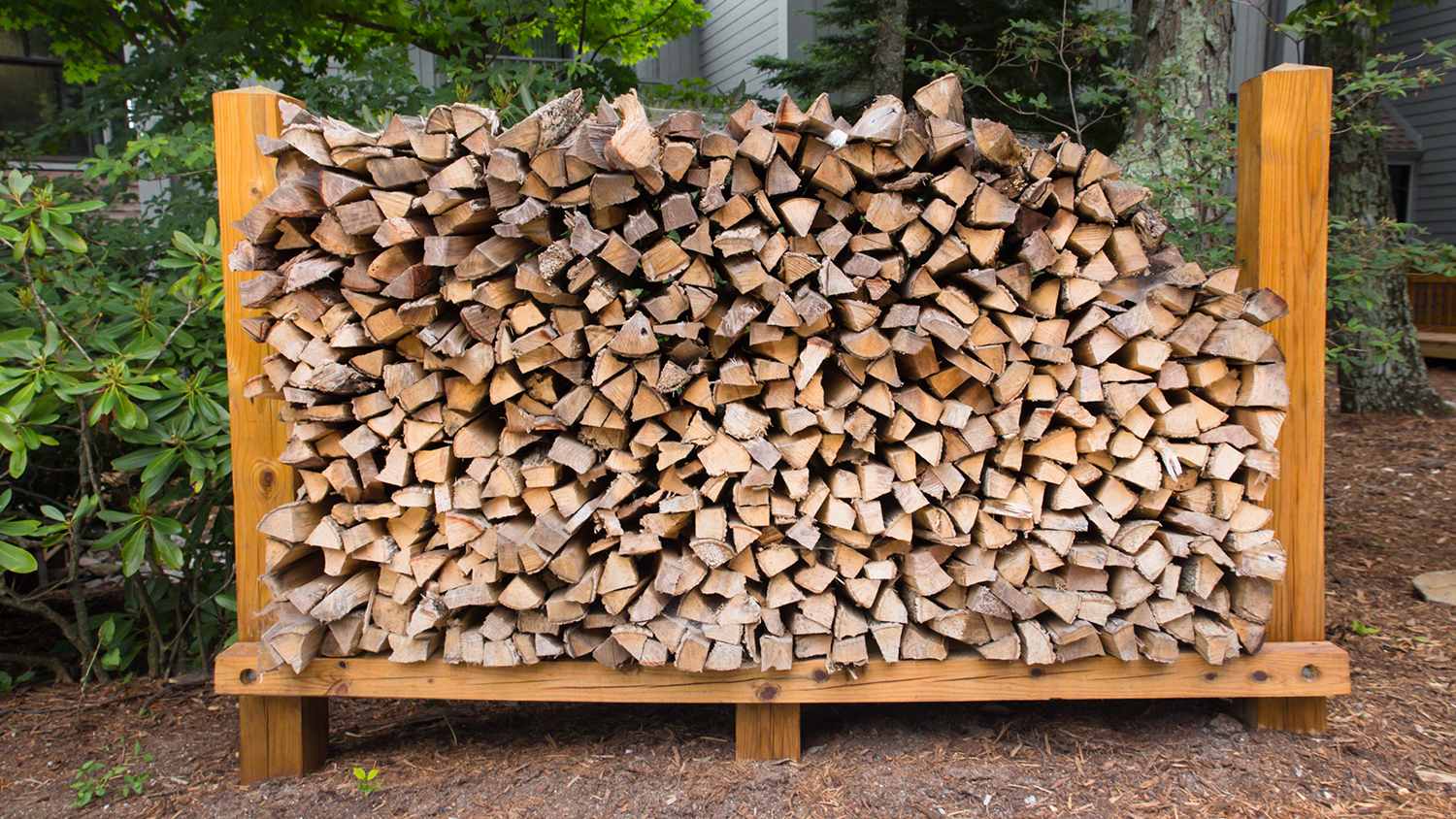 logs of fire wood stacked up outside