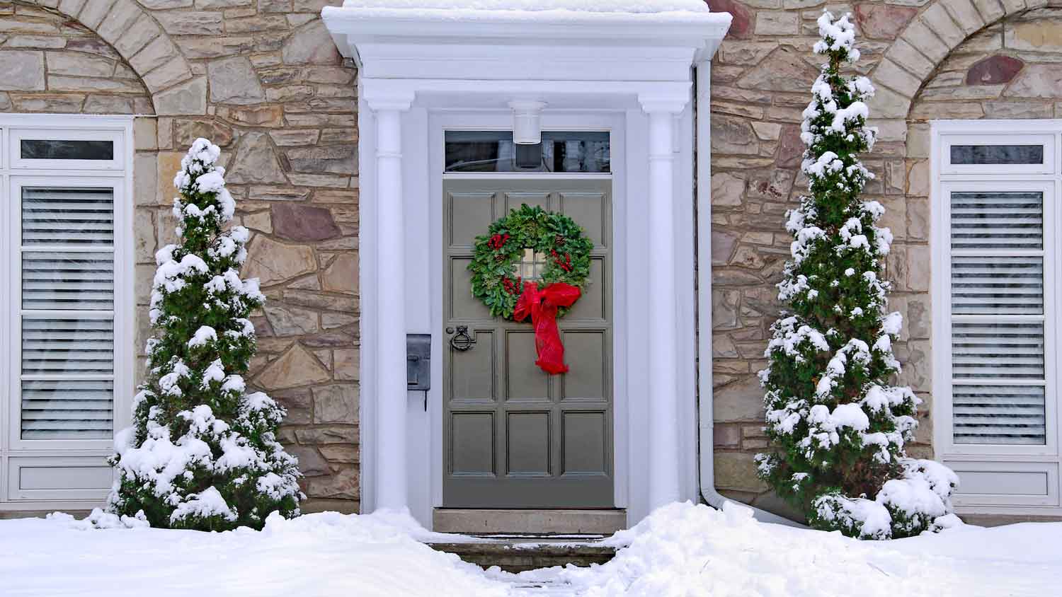 A Christmas wreath on the front door of a house