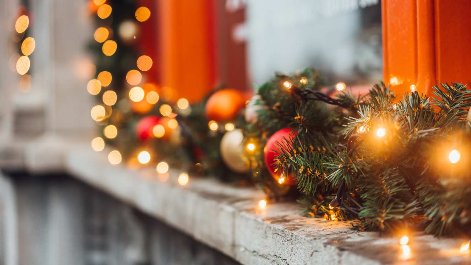 Close-up of Christmas lights decorating the exterior of a window