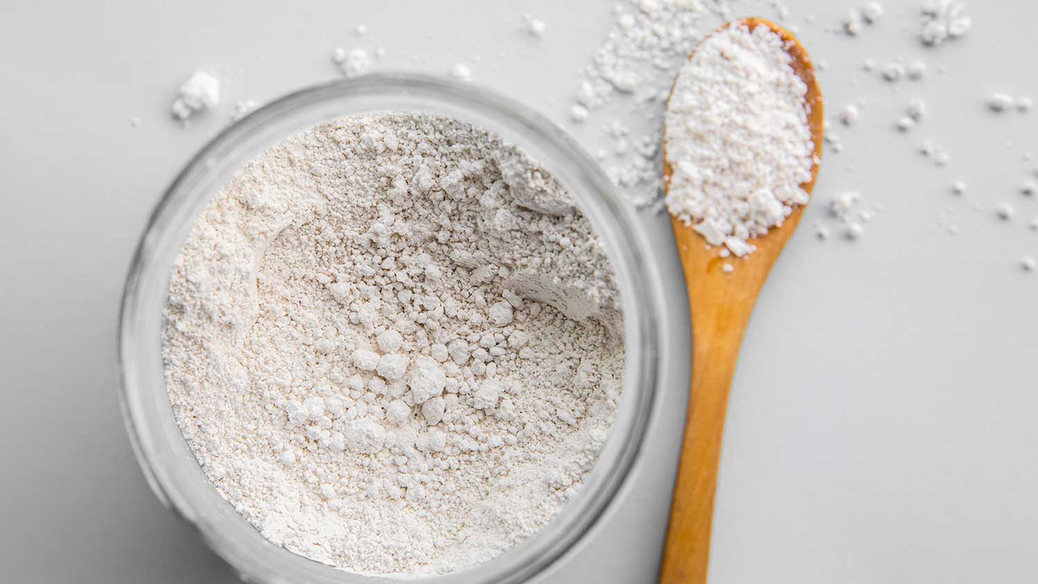 diatomaceous earth in a bowl and a wooden spoon