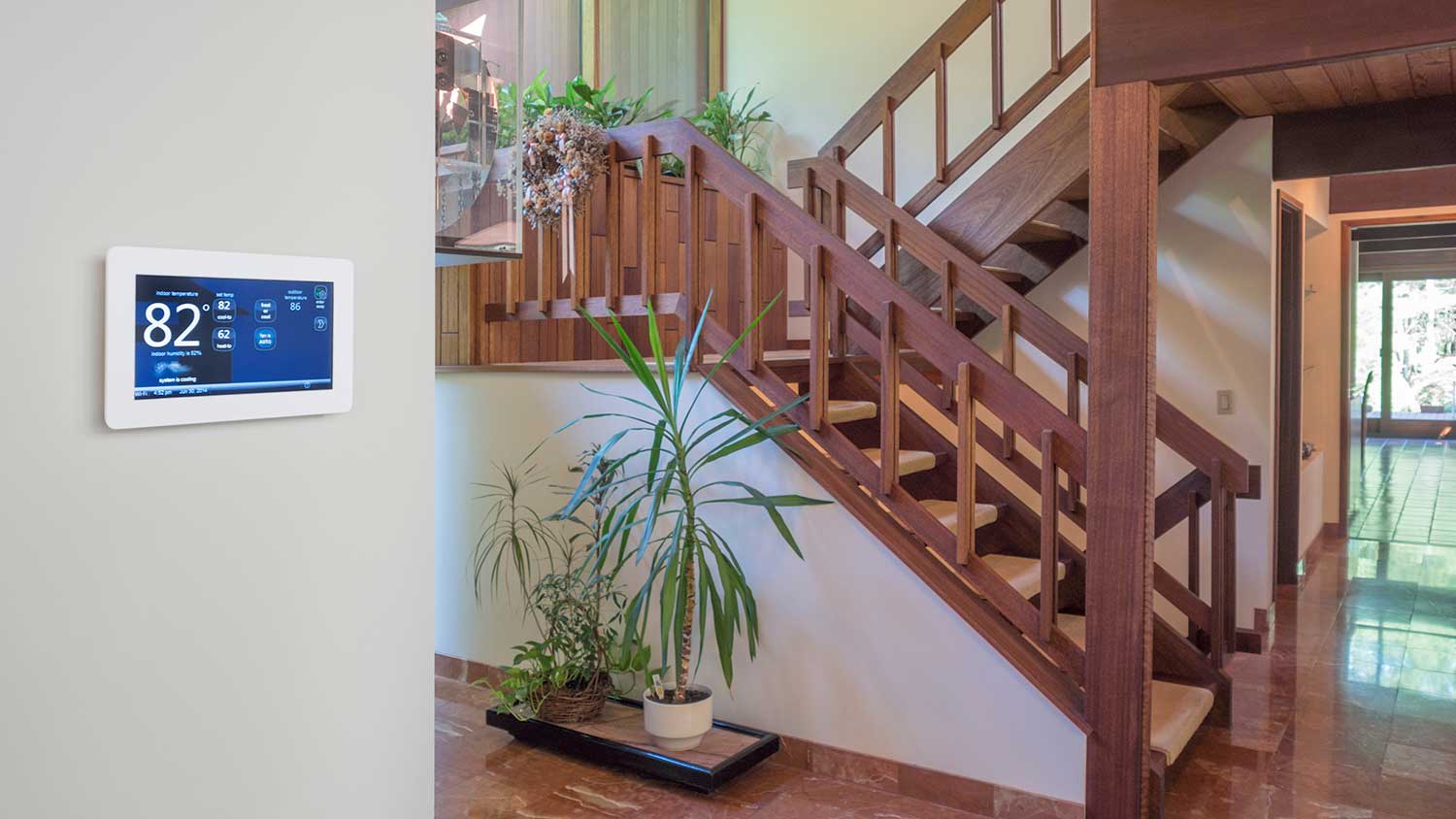 Smart thermostat installed in the hallway of a home