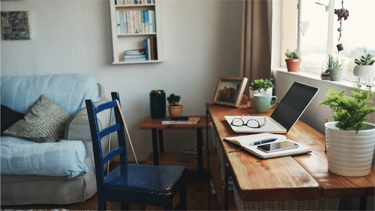 computer and notebook on a desk in home office during the day