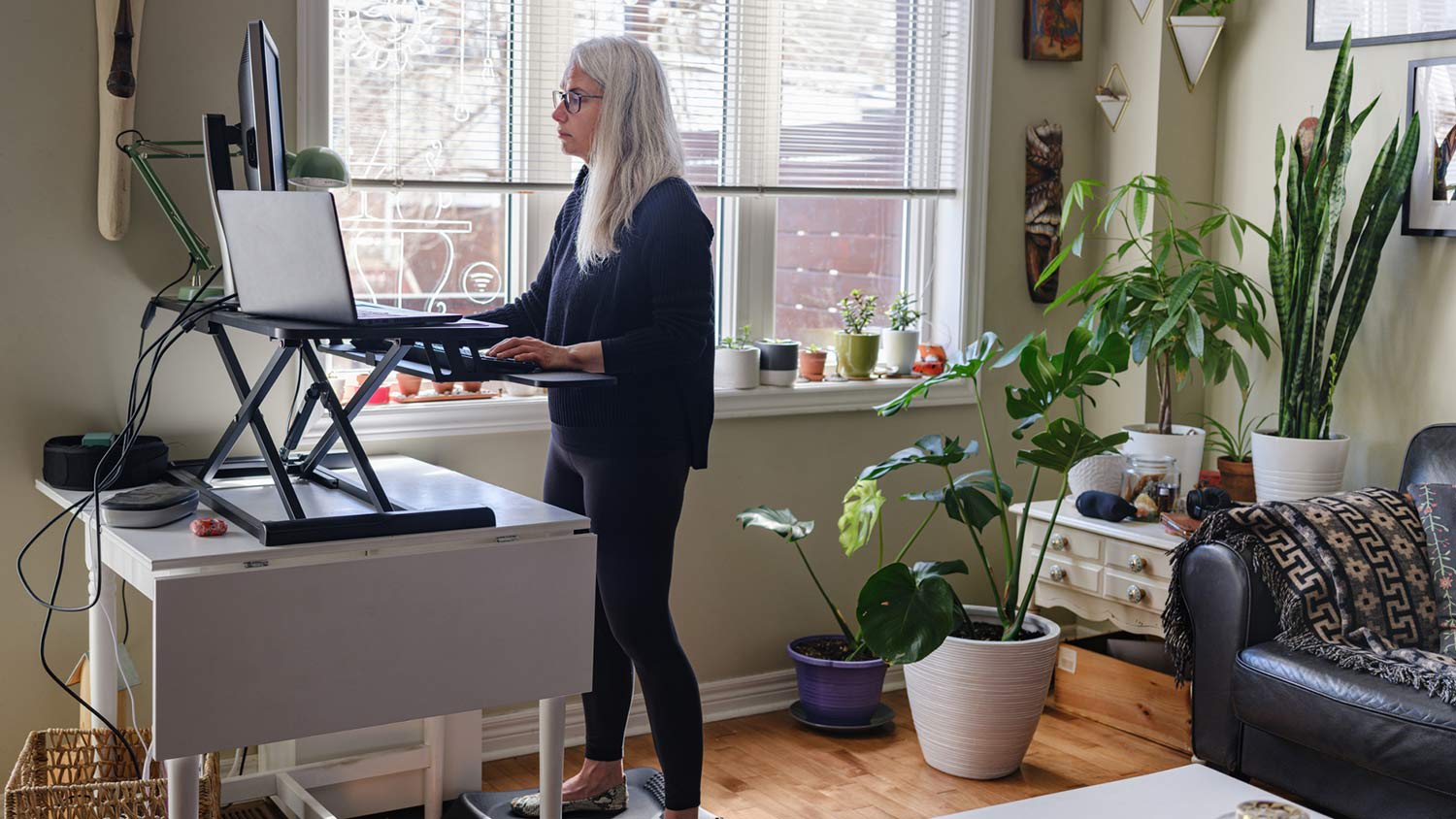 woman working on computer from home at the stand up desk