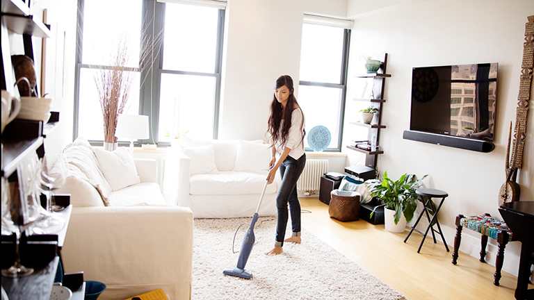 Woman vacuums carpet