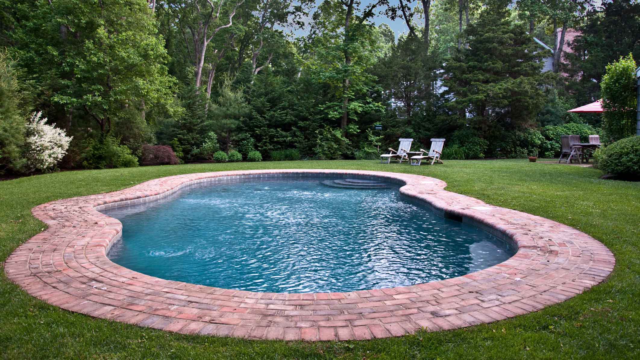A gunite pool in the backyard of a house