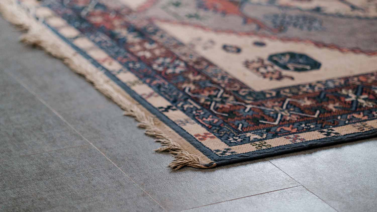 An ornamental wool carpet on a gray floor