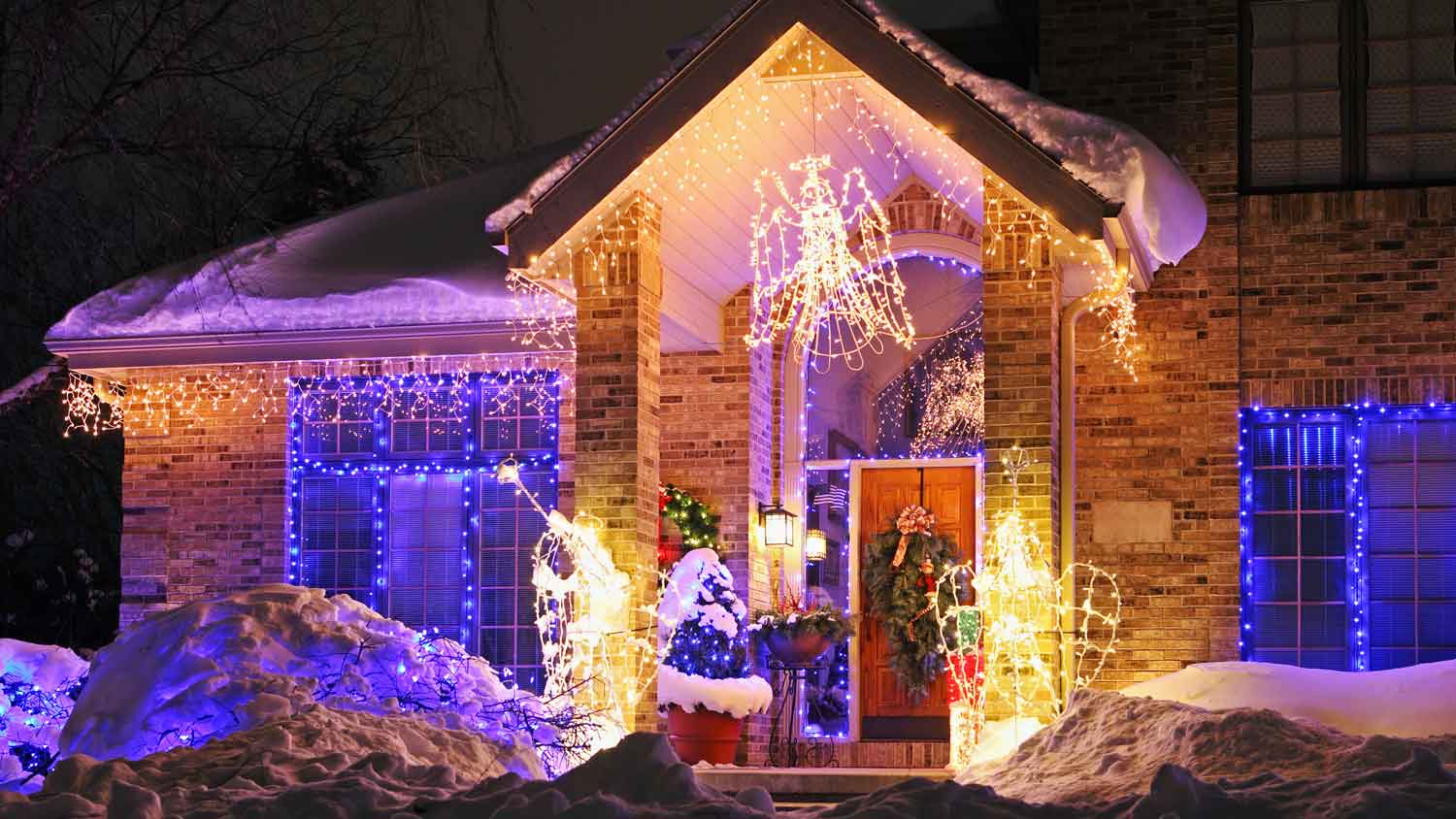 The exterior of a brick house decorated for Christmas