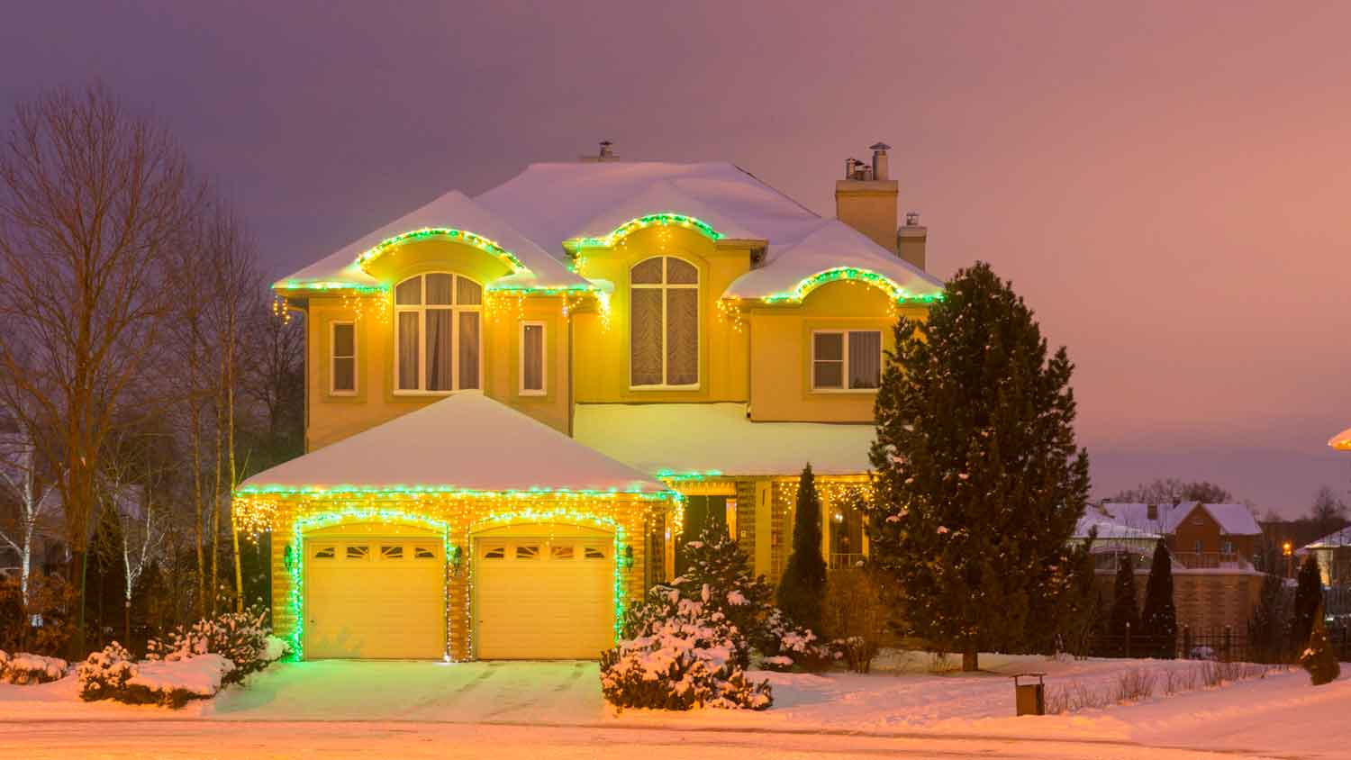 A house with a double garage door decorated for Christmas