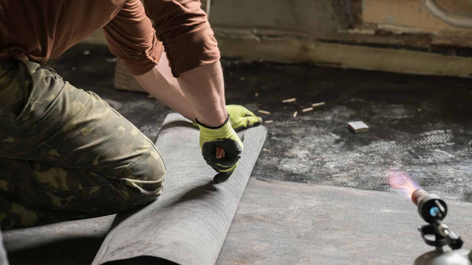 A professional waterproofing a basement floor