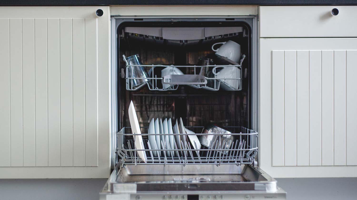 A loaded dishwasher in a modern kitchen