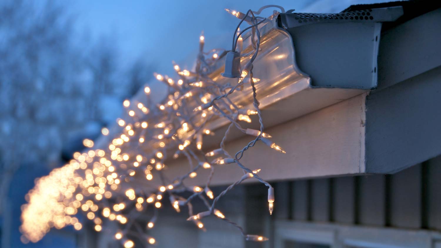 Illuminated Christmas lights hanged by the gutter