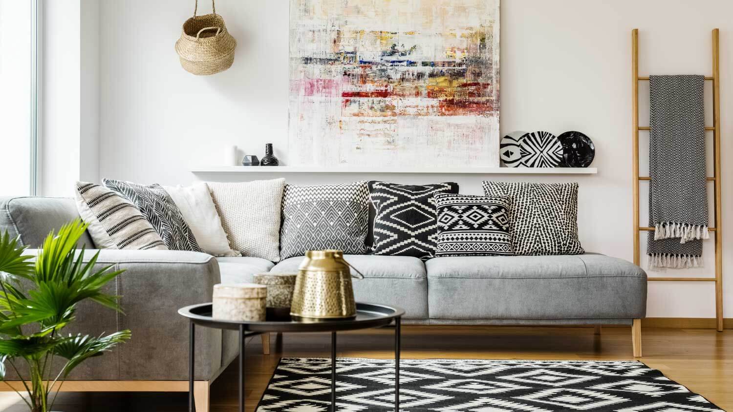 Living room with patterned pillows on grey corner sofa