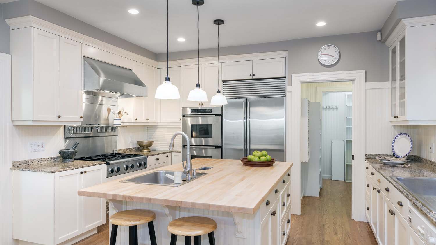 A luxurious kitchen with wooden floors and a kitchen island