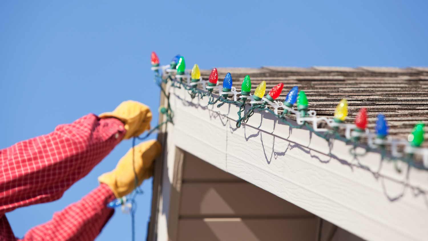 Man installing LED Christmas light