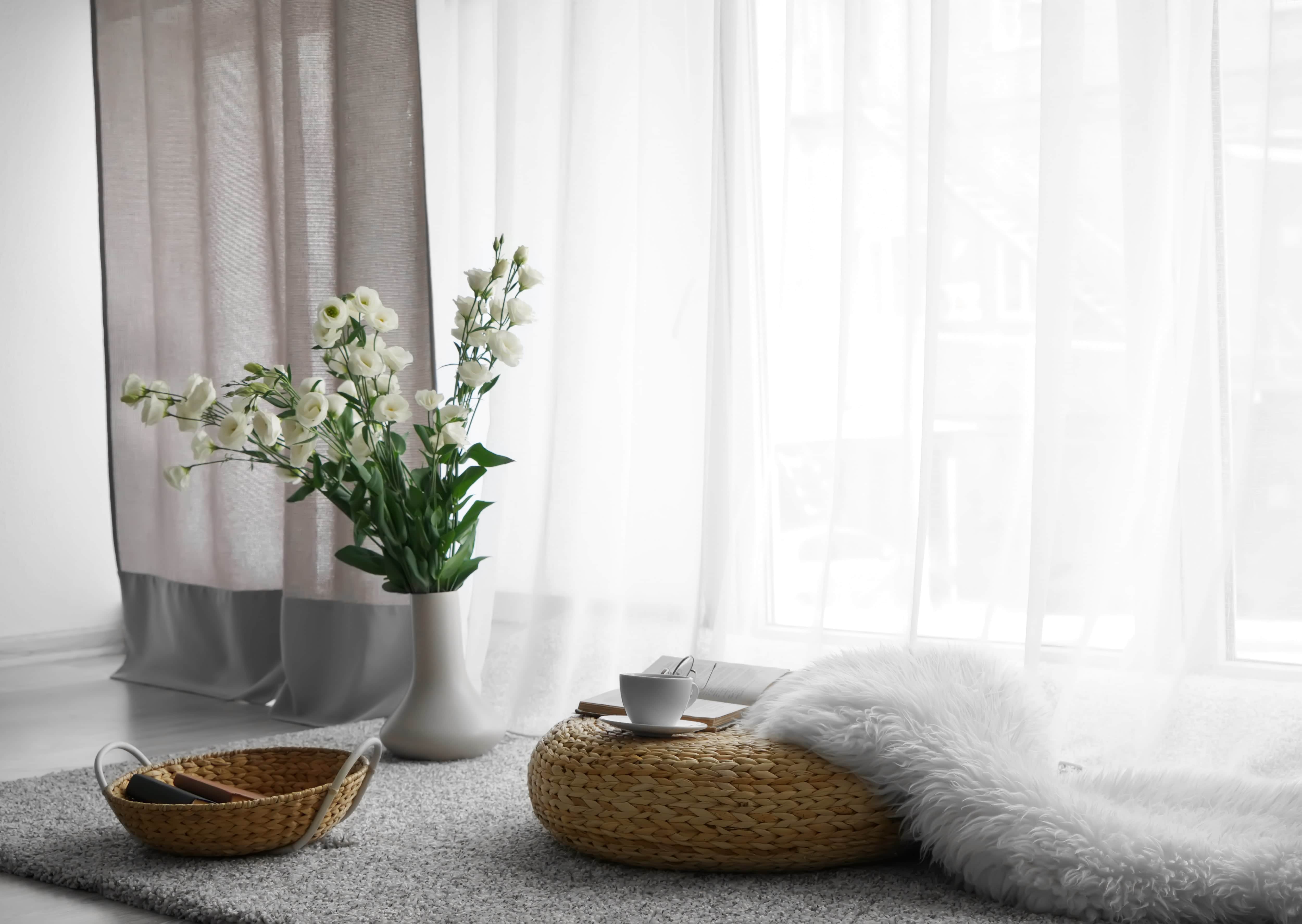 Straw floor pillow in front of window