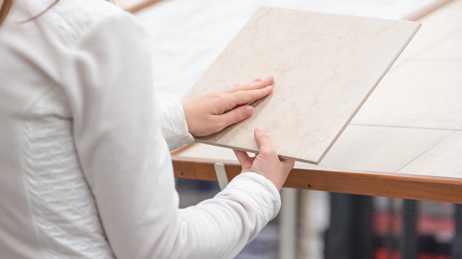 A woman choosing new ceramic floor tile