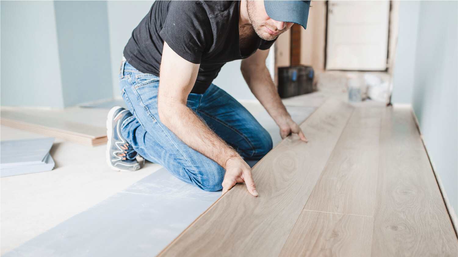 Male installing laminate on the floor