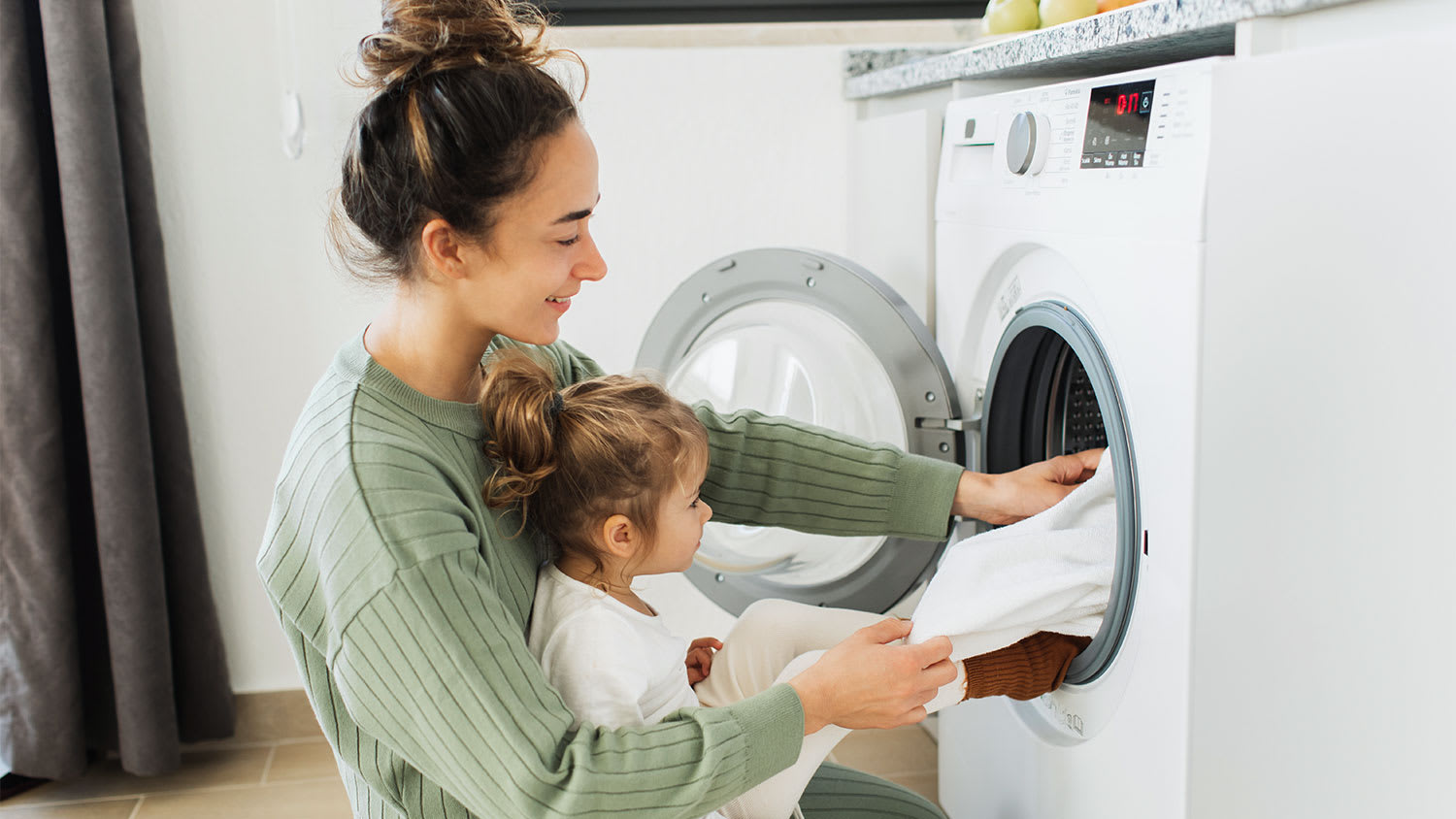 A mother and child do laundry