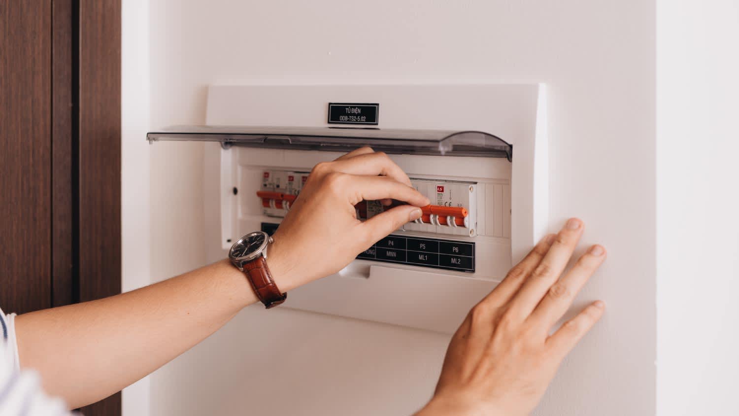 A woman checking electrical panel