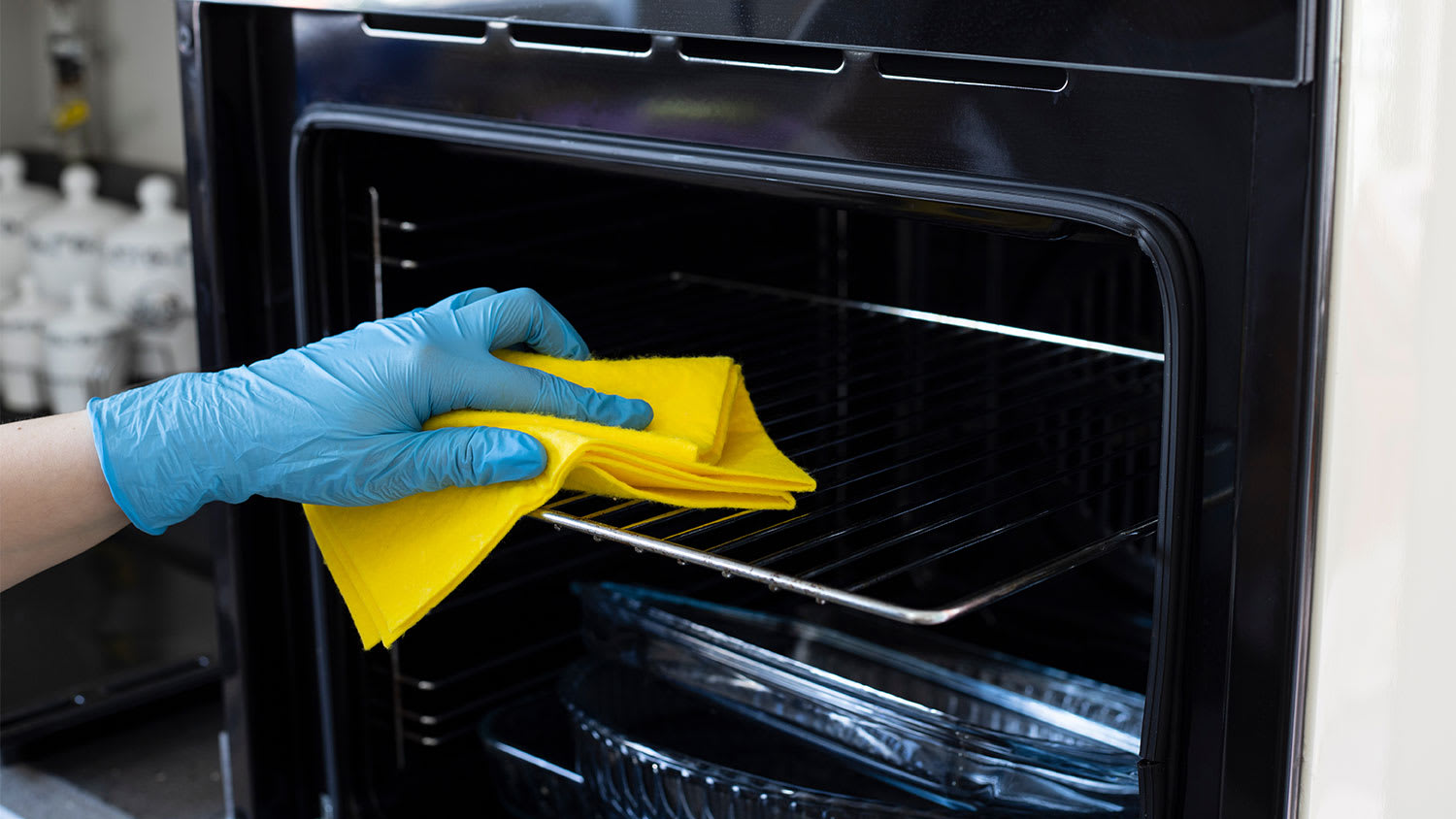 A view of a hand cleaning an oven