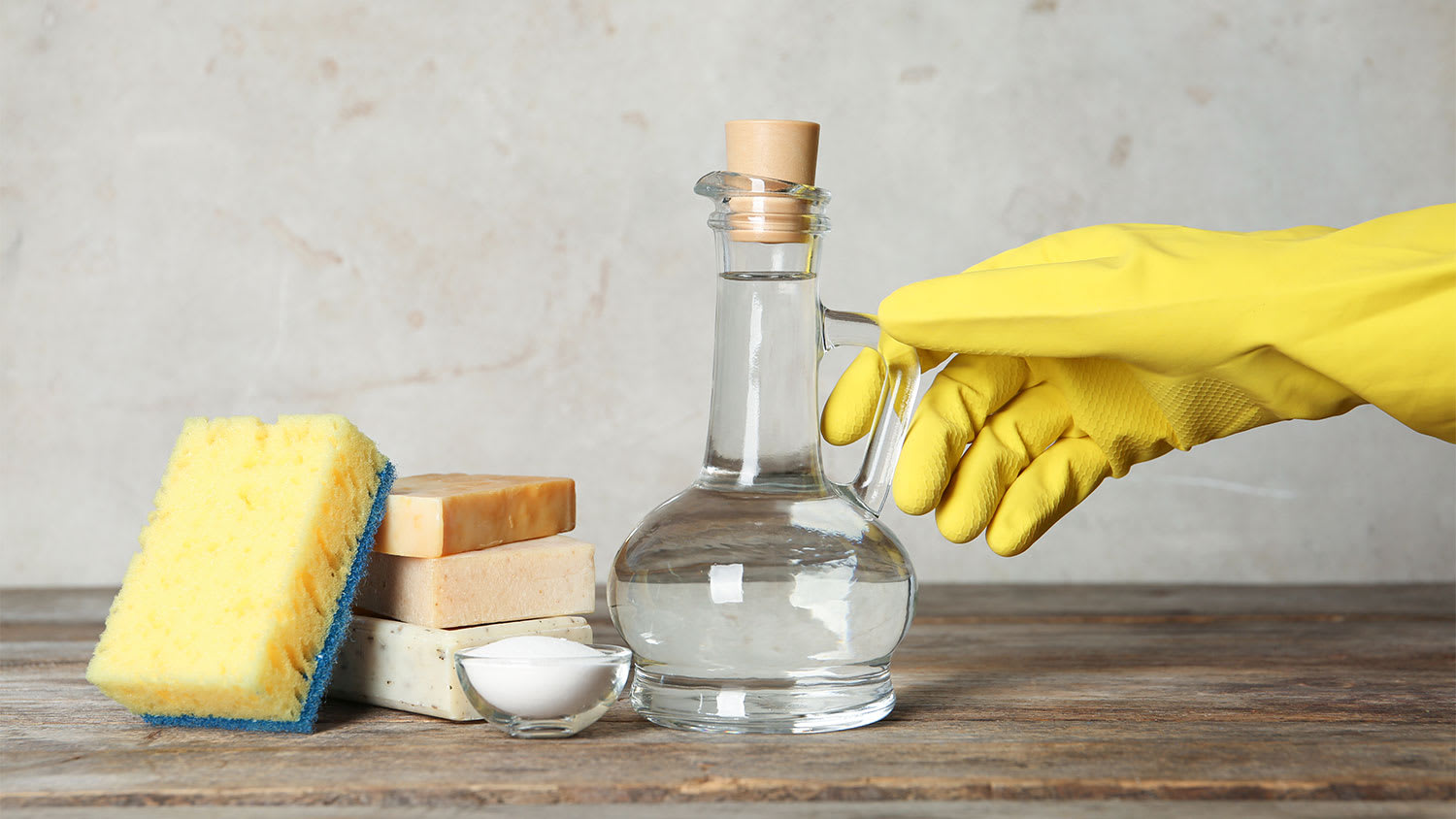 A person reaches for a vinegar bottle
