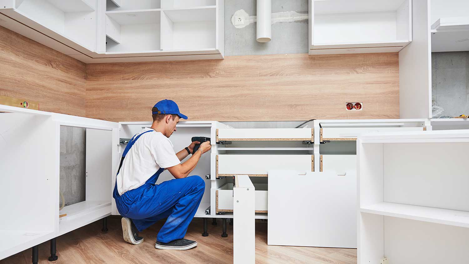 Carpenter assembling new kitchen cabinets