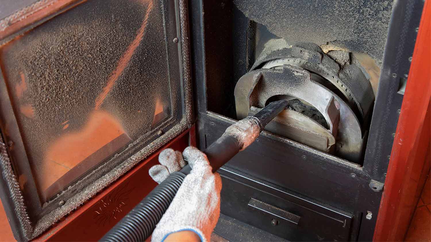 man cleaning pellet stove