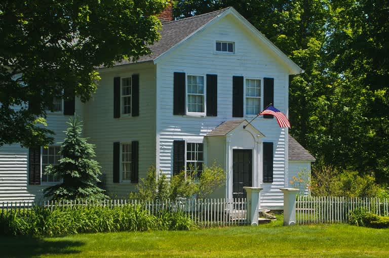Colonial style house with flag