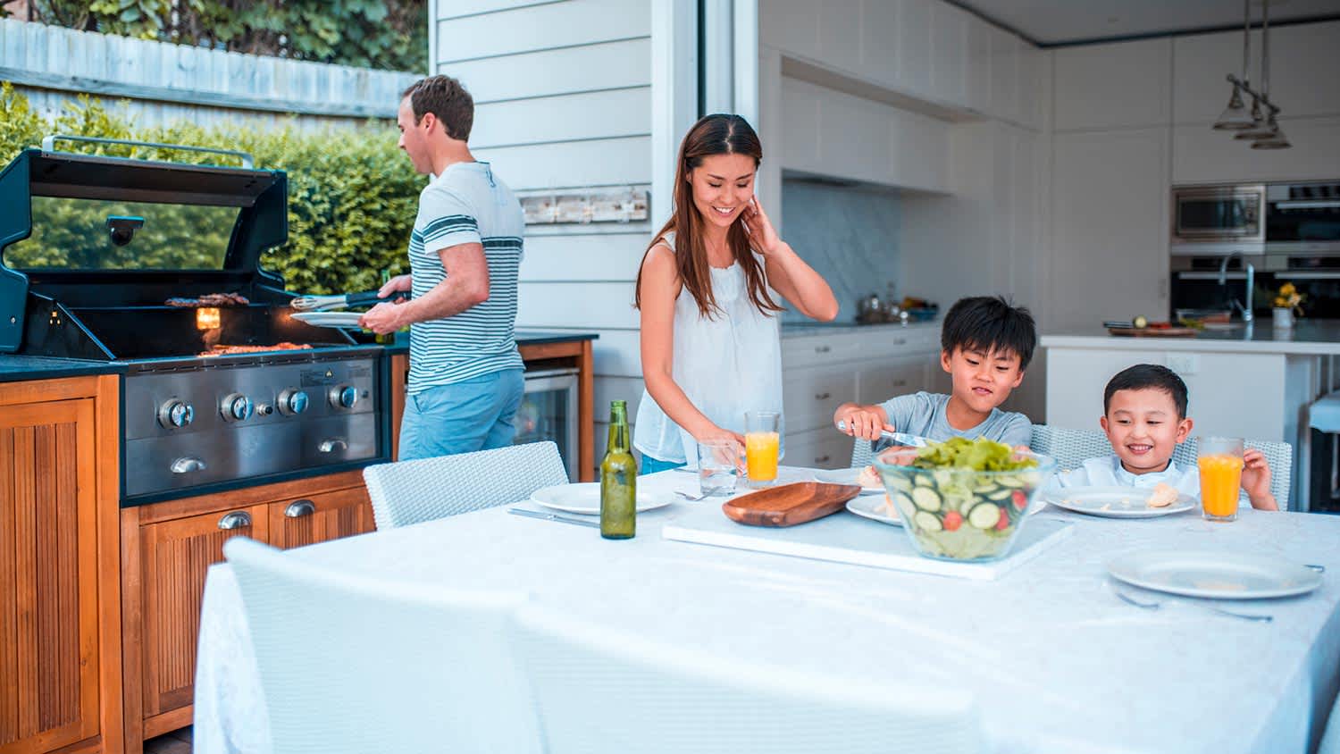 Father grilling out with family