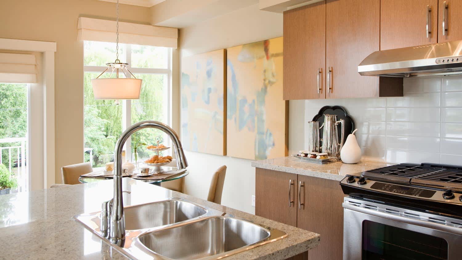A spacious kitchen and dining area with artwork hanged