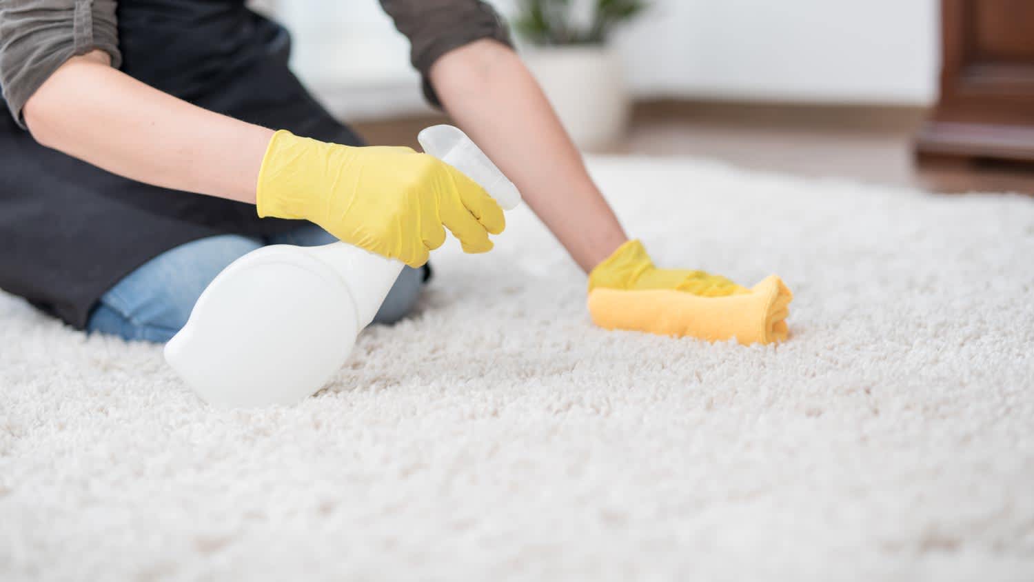 A man vacuuming carpet
