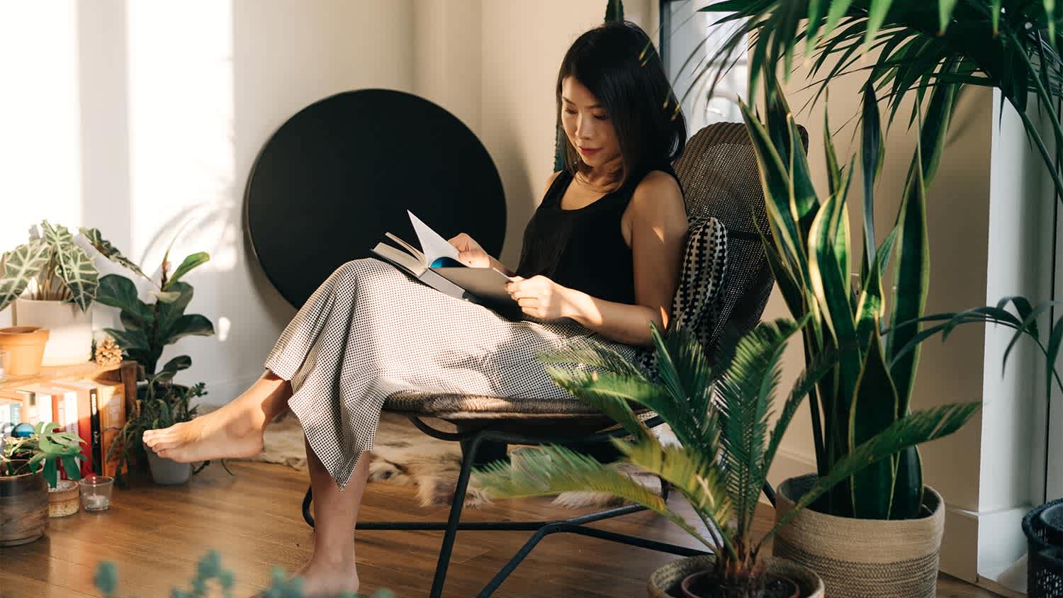 A woman reads a book at home