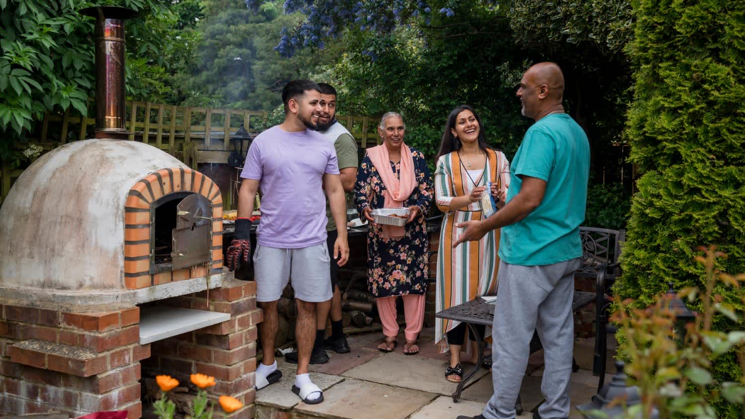 Family cooking in their outdoor kitchen