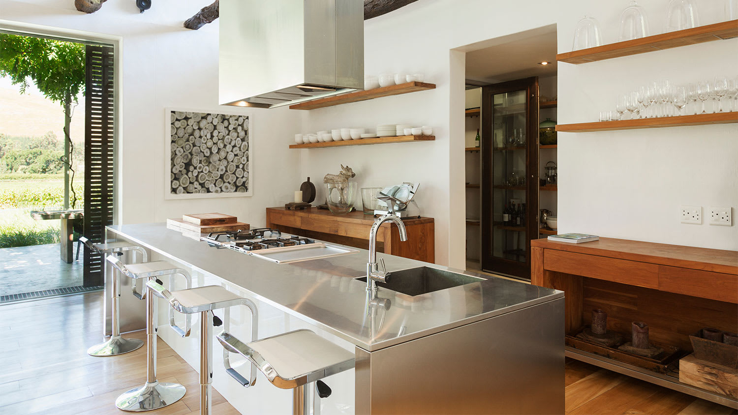 A view of a kitchen with mirrored finishes