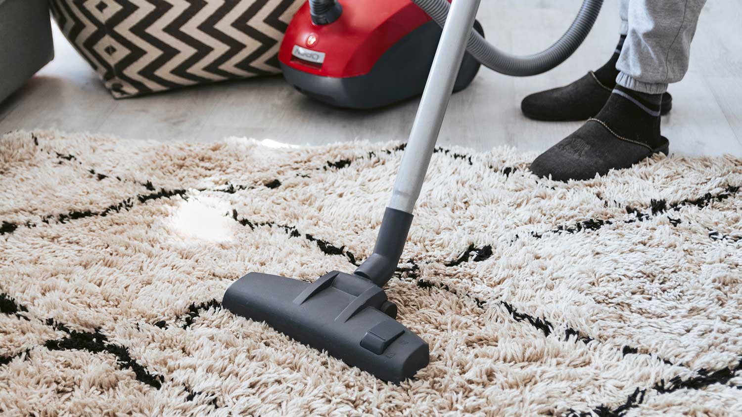 Closeup of a mane using vacuum cleaner